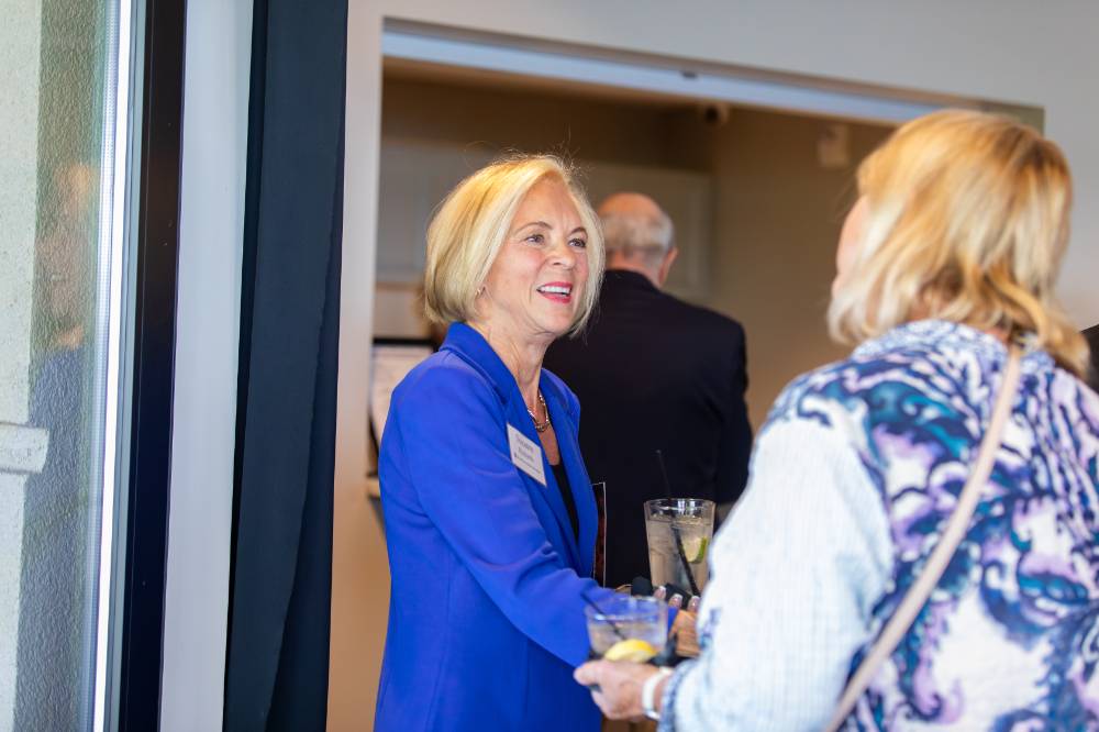 Suzanne Richards speaking wtih other attendee